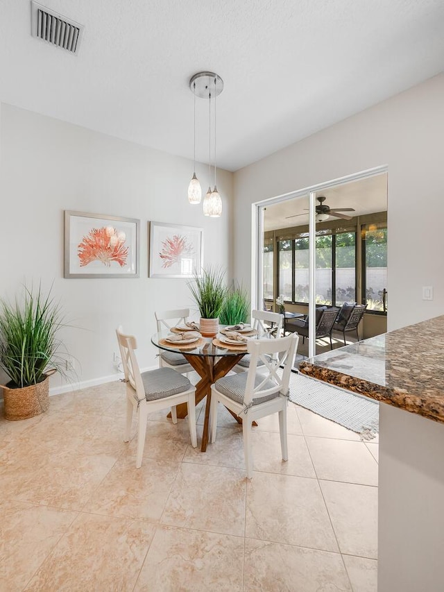 tiled dining room featuring ceiling fan