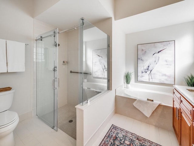 full bathroom featuring vanity, tile patterned flooring, toilet, and separate shower and tub