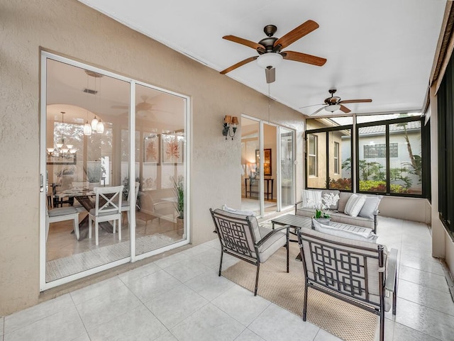 sunroom with ceiling fan with notable chandelier