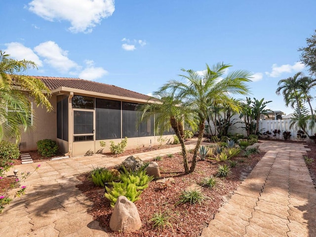 view of side of property featuring a sunroom