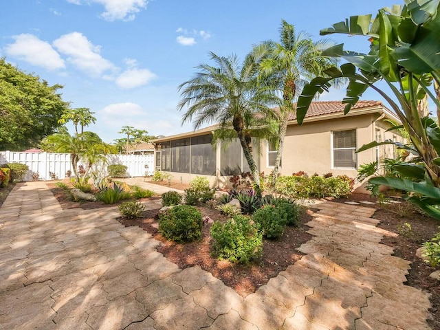 exterior space featuring a patio area and a sunroom