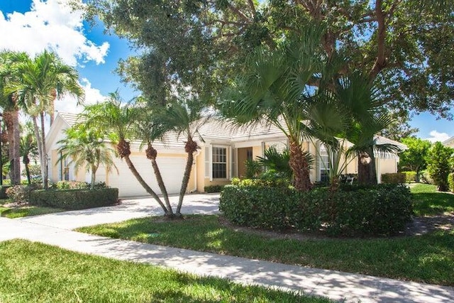 view of front of property featuring a garage and a front lawn