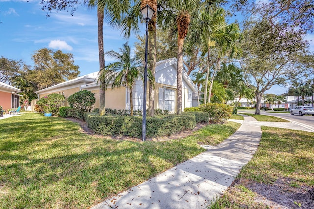 view of side of property featuring a yard