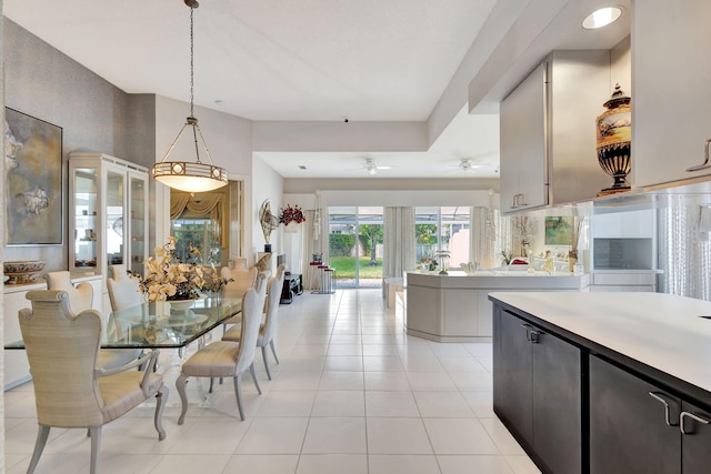 kitchen with light tile patterned flooring, ceiling fan, and decorative light fixtures