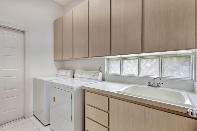 laundry room featuring cabinets, separate washer and dryer, sink, and light tile patterned floors