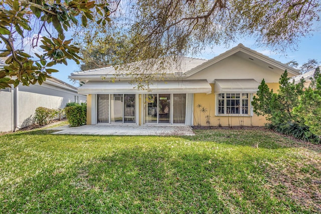 rear view of property with a yard