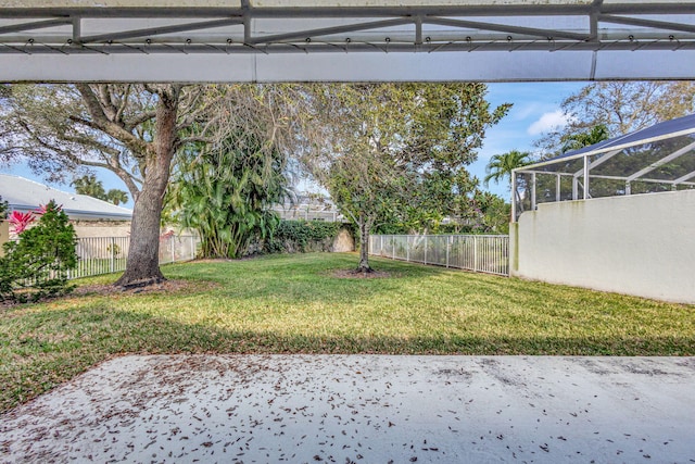 view of yard with a patio area and glass enclosure