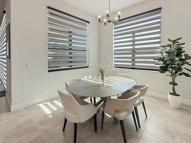 tiled dining room with an inviting chandelier