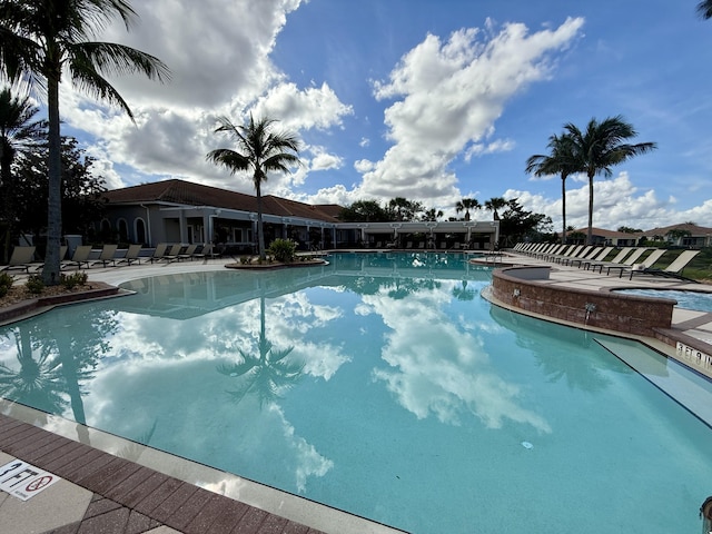 view of swimming pool with a jacuzzi