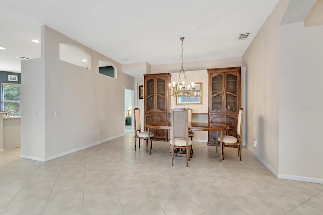 tiled dining area with an inviting chandelier