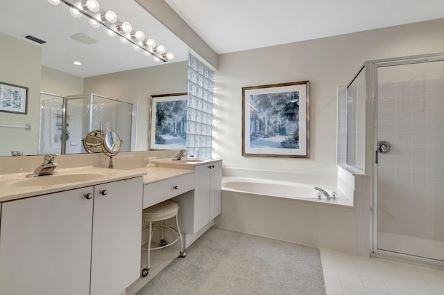 bathroom featuring independent shower and bath, vanity, and tile patterned floors