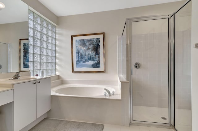 bathroom featuring vanity and separate shower and tub