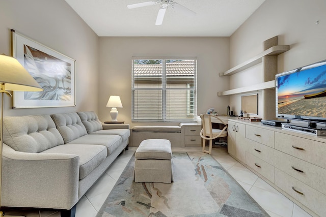 living room featuring light tile patterned flooring, built in desk, and ceiling fan