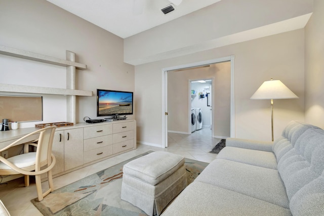 living room with light tile patterned flooring and washing machine and dryer