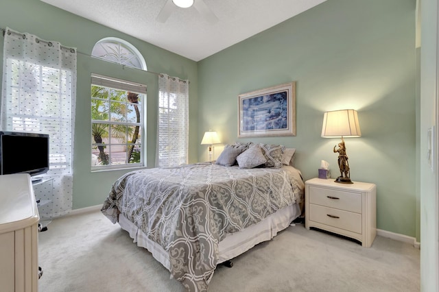 bedroom featuring ceiling fan and light carpet