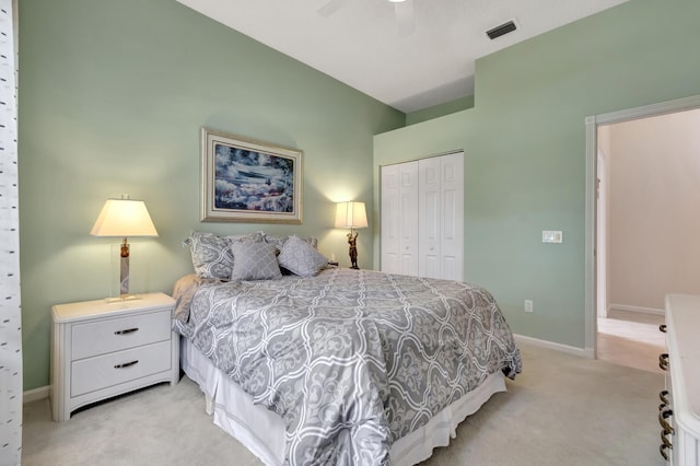 bedroom with light carpet, a closet, and ceiling fan