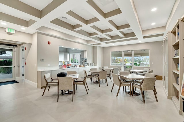 dining space with coffered ceiling, beamed ceiling, and a high ceiling