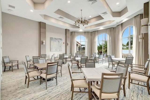 dining space with a high ceiling and a notable chandelier