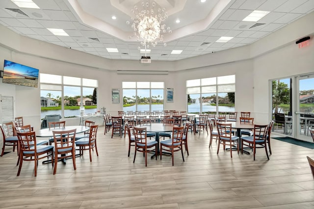 dining space with a towering ceiling and an inviting chandelier