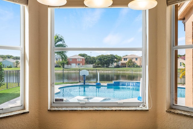 view of swimming pool with a water view