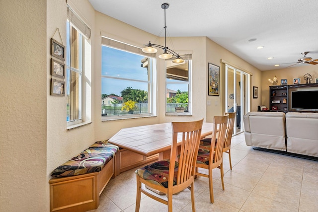 dining room with light tile patterned floors, a textured ceiling, and ceiling fan