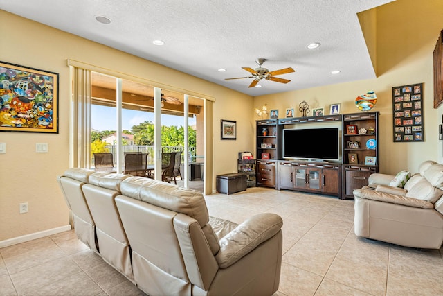 tiled living room featuring ceiling fan and a textured ceiling