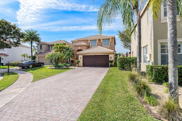 mediterranean / spanish-style home featuring a garage and a front lawn