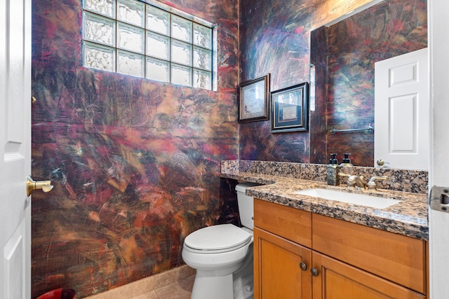 bathroom with vanity, toilet, and tile patterned flooring