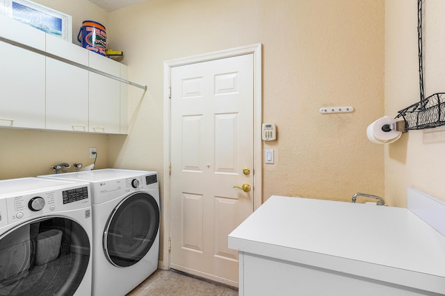 laundry area featuring separate washer and dryer, light tile patterned floors, and cabinets