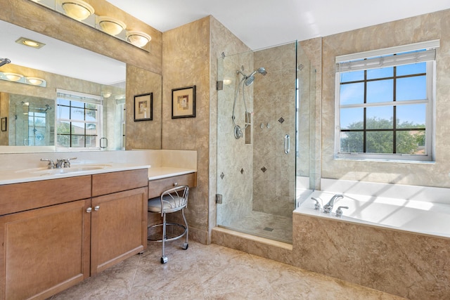 bathroom featuring shower with separate bathtub, plenty of natural light, and vanity