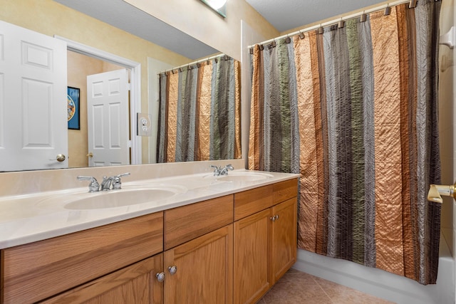 bathroom featuring tile patterned flooring, vanity, and shower / bath combo with shower curtain