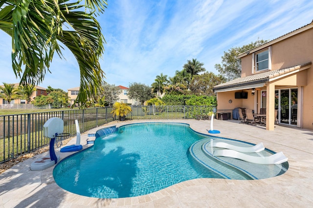 view of pool with a patio area and pool water feature