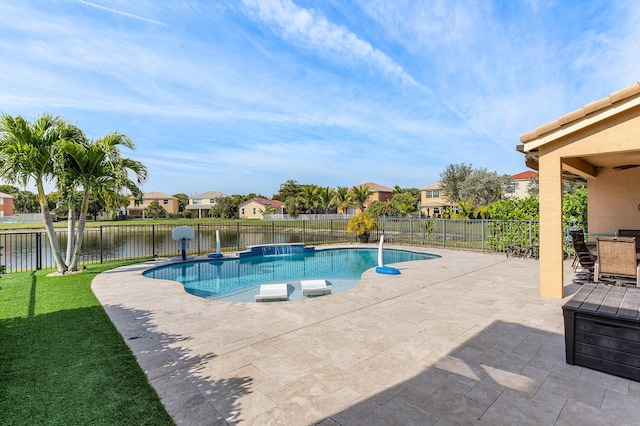 view of swimming pool featuring a patio area and a water view