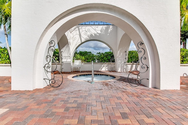 view of pool with an in ground hot tub