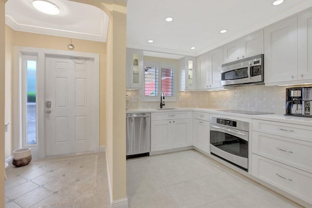 kitchen featuring white cabinetry, stainless steel appliances, sink, and tasteful backsplash