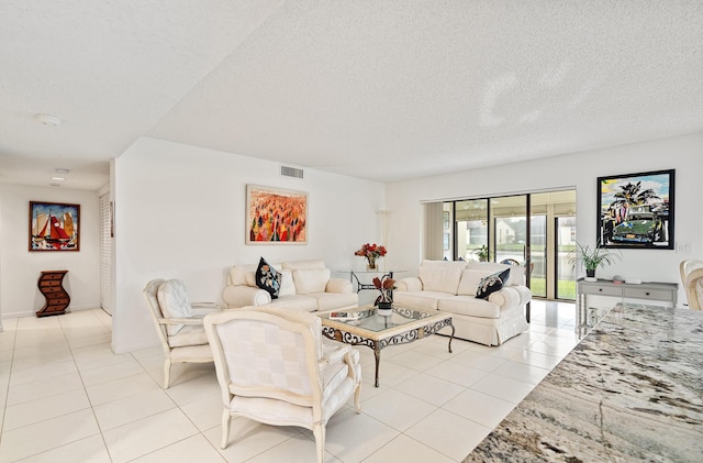 living room featuring a textured ceiling and light tile patterned floors