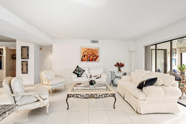 living room with light tile patterned flooring and a textured ceiling