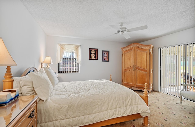 bedroom with a textured ceiling and ceiling fan