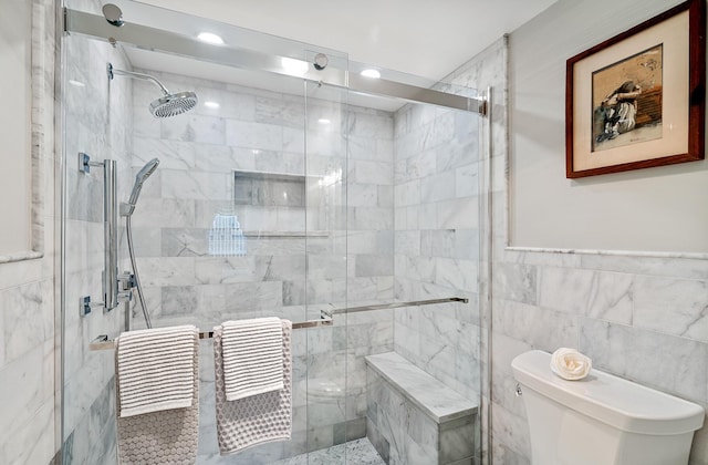 bathroom with tile walls, toilet, and walk in shower