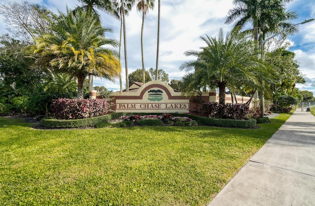 community / neighborhood sign with a lawn