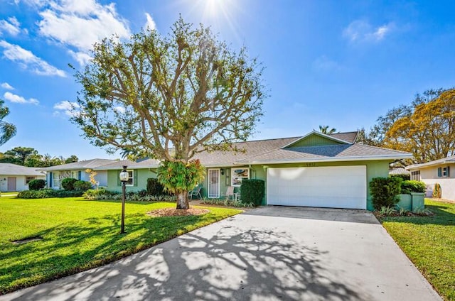 single story home featuring a garage and a front lawn