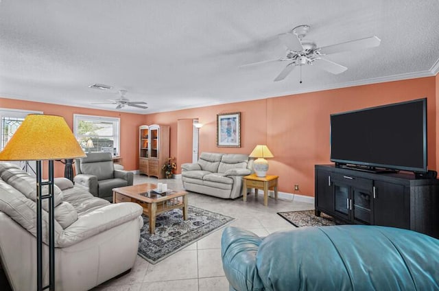 tiled living room featuring crown molding, ceiling fan, and a textured ceiling