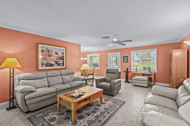 tiled living room featuring ceiling fan with notable chandelier, ornamental molding, and a textured ceiling