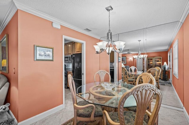 dining area featuring light tile patterned floors, crown molding, a textured ceiling, and a chandelier