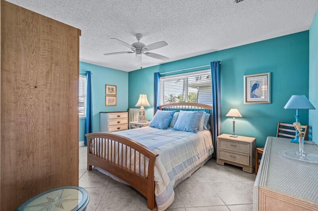 tiled bedroom featuring a textured ceiling and ceiling fan