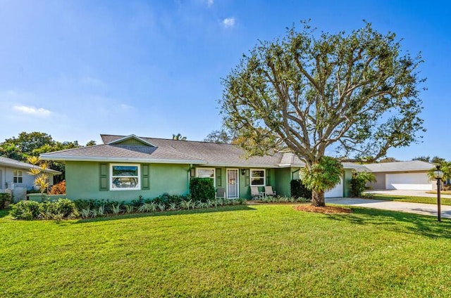 single story home with a garage and a front lawn