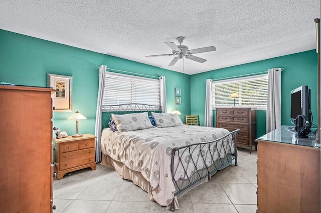 tiled bedroom with a textured ceiling and ceiling fan