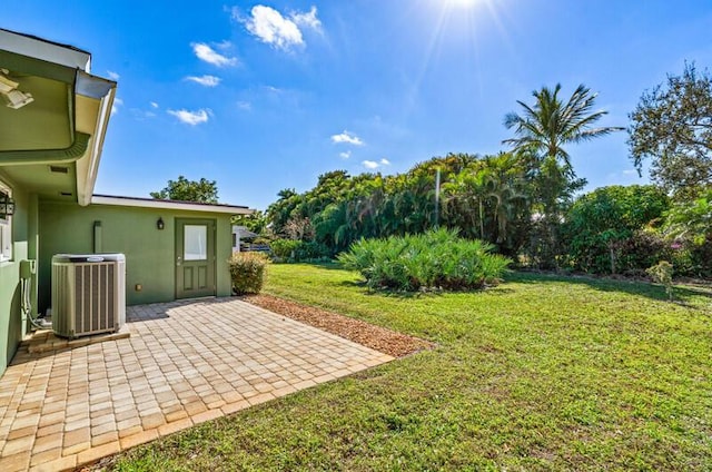 view of yard featuring central AC and a patio