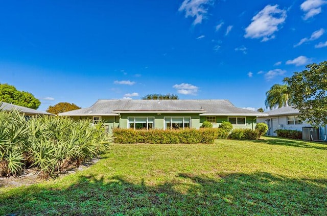 back of property with a lawn