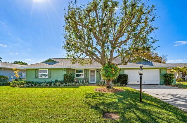 ranch-style house featuring a garage and a front yard